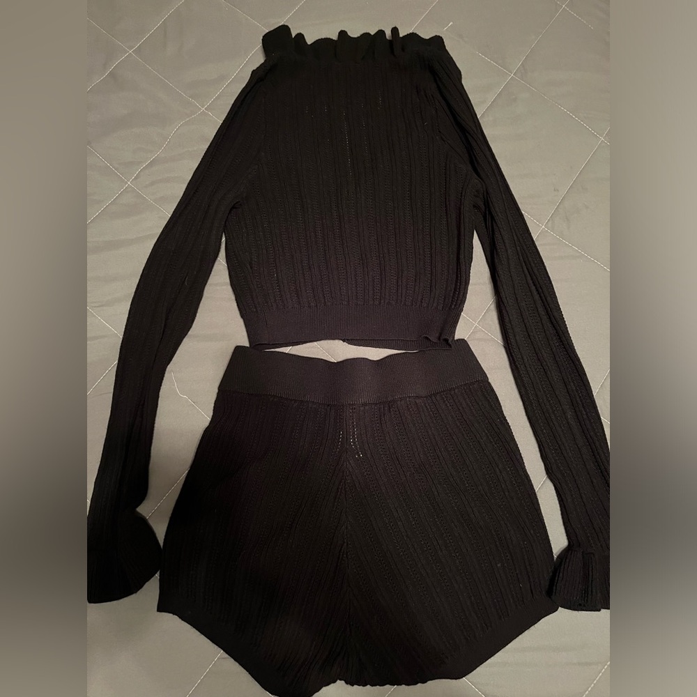 Black shorts cardigan and top.